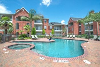 Swimming pool with spa and brick patio deck