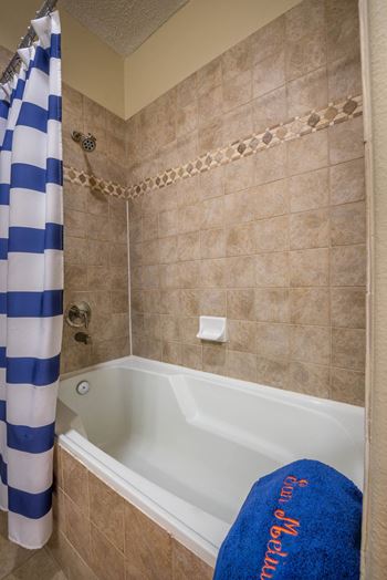 Bathroom with tiled tub and shower combination