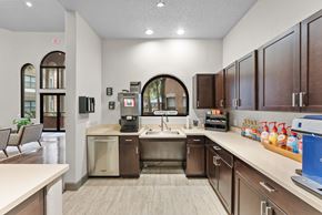 Houston apartment for rent - Coffee bar with dark wood cabinets and beverage station at Melia Medical Center Apartments, Houston, 77054
