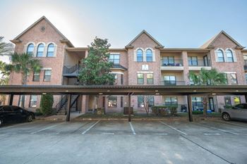 Brick apartment building with covered parking and balconies