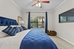 Houston apartment for rent - Bedroom with tufted headboard and large window at Melia Medical Center Apartments, Texas