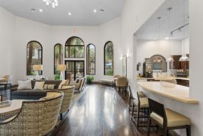 Houston apartment for rent - Clubhouse lounge with arched windows and kitchen area at Melia Medical Center Apartments, Houston, Texas
