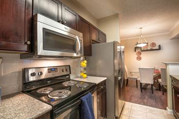 Modern kitchen with stainless steel appliances and dining area