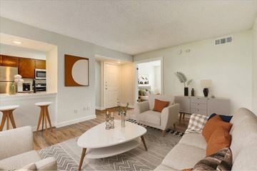 Garland apartment for rent - A living room with a white couch and a coffee table.