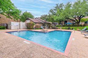Garland apartment for rent - Resort style pool with patio seating area at The Courtyard Apartments, Garland, Texas