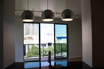 Dining area with pendant lighting and balcony view
