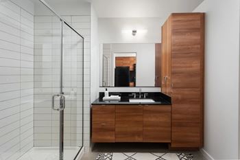 Modern bathroom with wood vanity and glass shower
