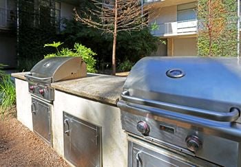 Outdoor grilling area with built in barbecue stations