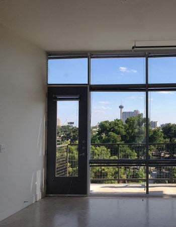Loft interior with city skyline views and private balcony