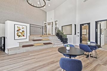 La Mesa apartment for rent - A modern living room with a staircase and a painting on the wall.