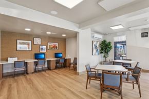 Orange apartment for rent - A conference room with a long table and chairs at The Orion Senior Apartments - Orange, CA Apartments, Orange, CA, 92866