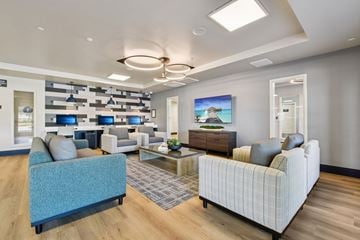 Roseville apartment for rent - A modern living room with a blue sofa and a painting on the wall.