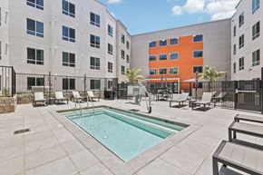 La Mesa apartment for rent - A pool surrounded by chairs and a fence.