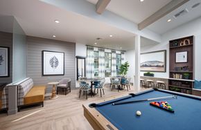 Gold River apartment for rent - Rancho Cordova, CA Pet-Friendly Garden-Style Apartments - Aurora - Clubhouse with Couch, Armchair, Coffee Table, Tables and Chairs, Bookshelf, and Billiards Table.