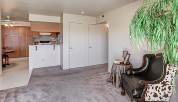 Reno apartment for rent - A living room with a brown leather chair and a cowhide ottoman.