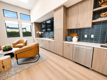 Roseville apartment for rent - A kitchen with a yellow chair and wooden cabinets.