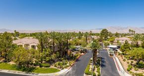 Las Vegas apartment for rent - A residential street with houses and palm trees.