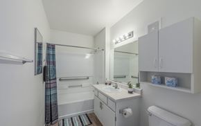 Las Vegas apartment for rent - A white bathroom with a toilet, sink, and shower.