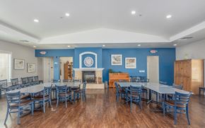 Las Vegas apartment for rent - A large dining room with a fireplace and blue walls.