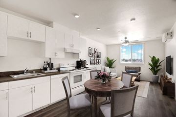 Panorama City apartment for rent - A modern kitchen with a dining table set for four.