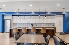 Santa Clara apartment for rent - A modern kitchen with a long table and chairs.at Mainline North Apartments - Santa Clara, CA, California