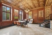 St. Louis apartment for rent - a dining room with wood paneled walls and a table with chairs  at The Embassy in St Louis