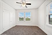 St. Louis apartment for rent - an empty bedroom with a ceiling fan and two windows  at The Embassy in St. Louis, 63108