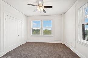 St. Louis apartment for rent - an empty bedroom with a ceiling fan and two windows  at The Embassy in St. Louis, 63108