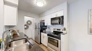 Columbus apartment for rent - a kitchen with stainless steel appliances and white cabinets at Island Club Apartments, Columbus