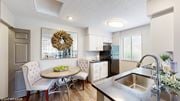 Dublin apartment for rent - a kitchen with a sink and a table with chairs at Karric Place of Dublin Apartments, Ohio, 43016