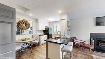 Dublin apartment for rent - a living room and kitchen with a fireplace and a table with chairs