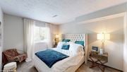 Columbus apartment for rent - a bedroom with a bed and a chair and a window at Runaway Bay Apartments, Columbus, Ohio