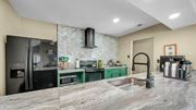 Memphis apartment for rent - A kitchen with a marble countertop and green cabinets.