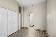 St. Louis apartment for rent - an empty bedroom with white doors and wood flooring at Delmar Loop Apartments, Missouri, 63112