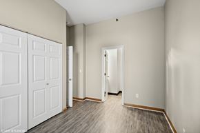 St. Louis apartment for rent - an empty bedroom with white doors and wood flooring at Delmar Loop Apartments, Missouri, 63112