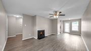 Memphis apartment for rent - A spacious room with a fireplace and a ceiling fan.