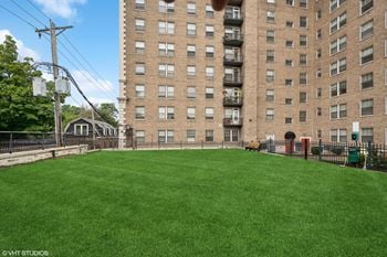 A large yard in front of a tall building