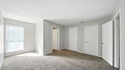 Cordova townhouse for rent - A sparsely furnished room with a carpeted floor and white walls.
