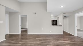 Memphis apartment for rent - A spacious living room with wood flooring and white walls.