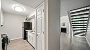 Cordova townhouse for rent - A kitchen with white cabinets and a black fridge is shown.