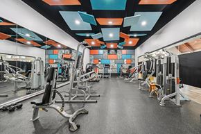Columbus apartment for rent - A gym with a variety of equipment including weights and machines.