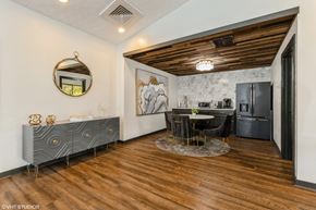 Columbus apartment for rent - a kitchen and dining room with a black refrigerator and a table and chairs at Springburne at Polaris Apartments, Ohio