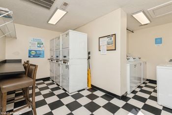 A kitchen with a checkered floor and a refrigerator