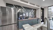 Memphis apartment for rent - A modern kitchen with a stainless steel refrigerator and a marble countertop.