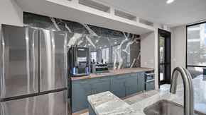 Memphis apartment for rent - A modern kitchen with a stainless steel refrigerator and a marble countertop.