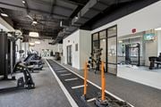 St. Louis apartment for rent - A gym with a variety of equipment including treadmills, weights, and exercise machines. at The Era Collective, St. Louis, 63108