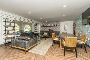 A living room with a couch and a table and a tv