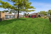Columbus apartment for rent - a yard with a playground and houses in the background at Springburne at Polaris Apartments, Columbus, 43235