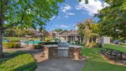 Memphis apartment for rent - A backyard with a fire pit and a pool in the background.
