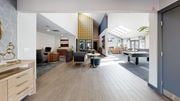 Tacoma apartment for rent - A spacious office lobby with a reception desk and seating area.